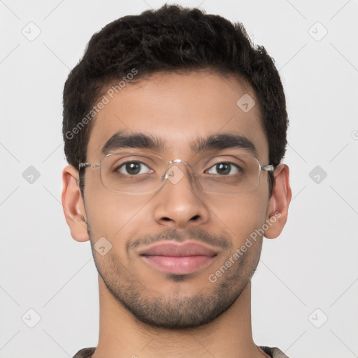 Joyful latino young-adult male with short  brown hair and brown eyes