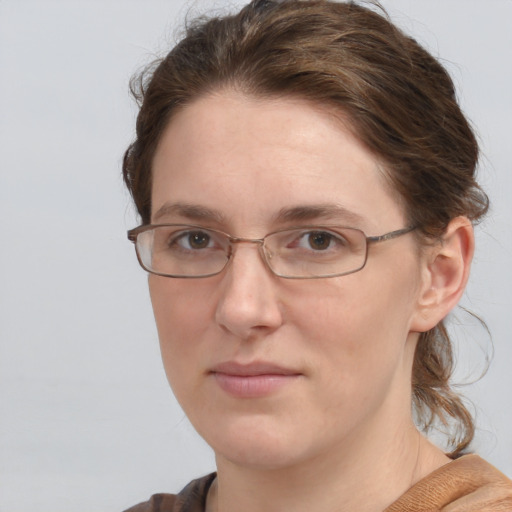 Joyful white adult female with medium  brown hair and grey eyes