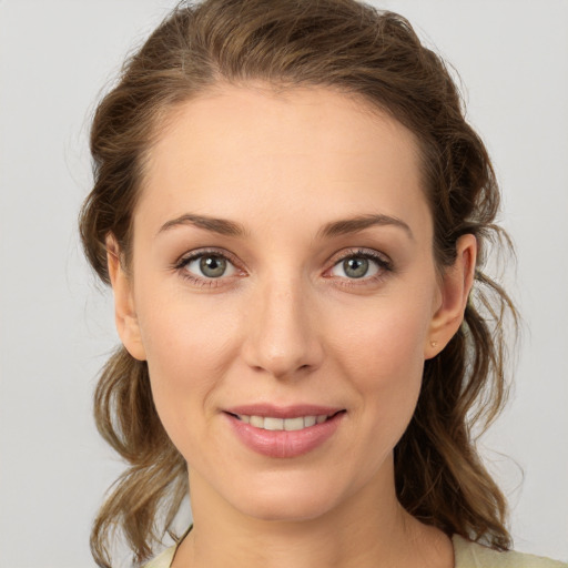 Joyful white young-adult female with medium  brown hair and grey eyes