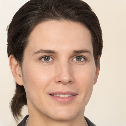 Joyful white young-adult male with medium  brown hair and brown eyes