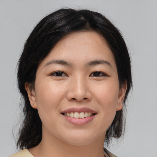 Joyful asian young-adult female with medium  brown hair and brown eyes