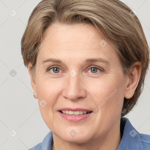 Joyful white adult female with medium  brown hair and grey eyes