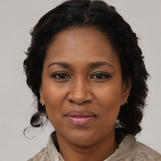 Joyful black adult female with medium  black hair and brown eyes