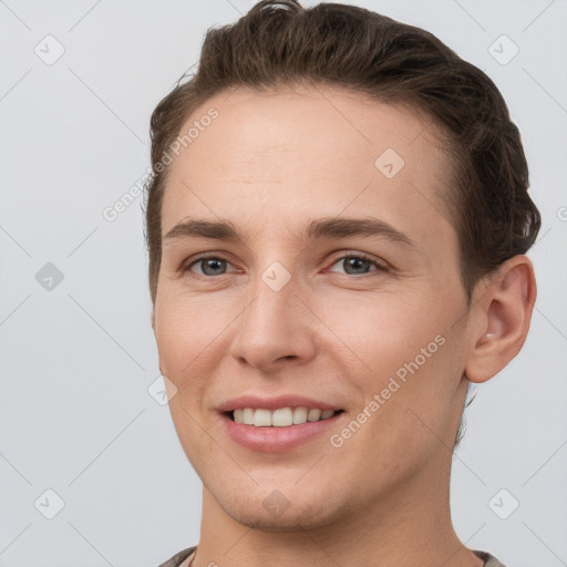 Joyful white young-adult female with short  brown hair and grey eyes