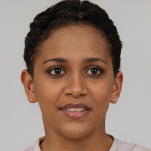 Joyful black young-adult female with short  brown hair and brown eyes