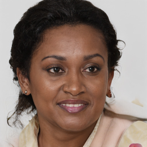 Joyful black adult female with medium  brown hair and brown eyes