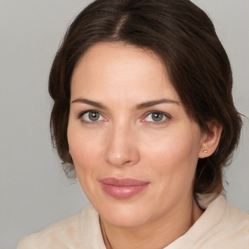 Joyful white adult female with medium  brown hair and brown eyes