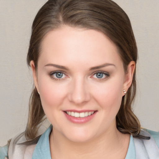 Joyful white young-adult female with medium  brown hair and blue eyes