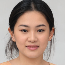 Joyful asian young-adult female with medium  brown hair and brown eyes