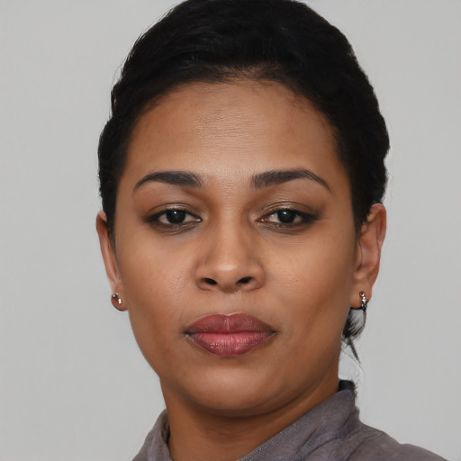 Joyful black young-adult female with short  black hair and brown eyes