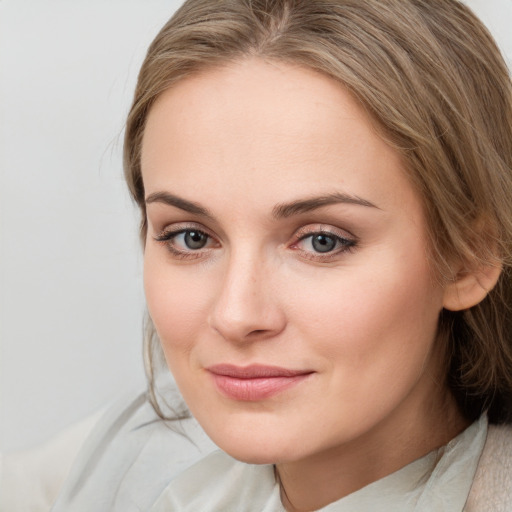 Joyful white young-adult female with medium  brown hair and blue eyes