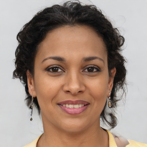 Joyful latino young-adult female with short  brown hair and brown eyes