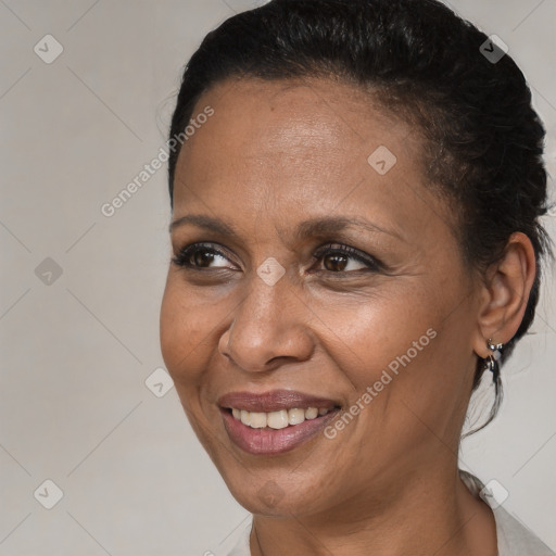 Joyful black adult female with short  brown hair and brown eyes