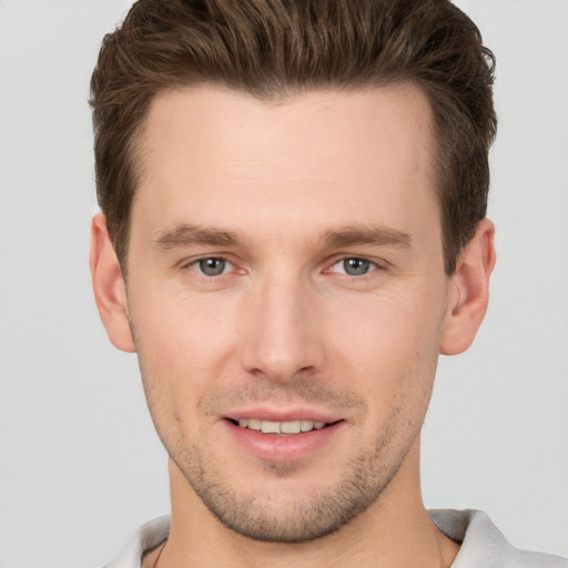 Joyful white young-adult male with short  brown hair and brown eyes