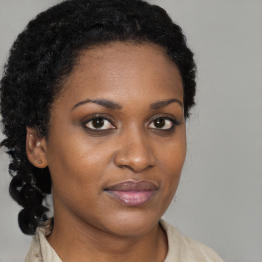 Joyful black young-adult female with medium  black hair and brown eyes