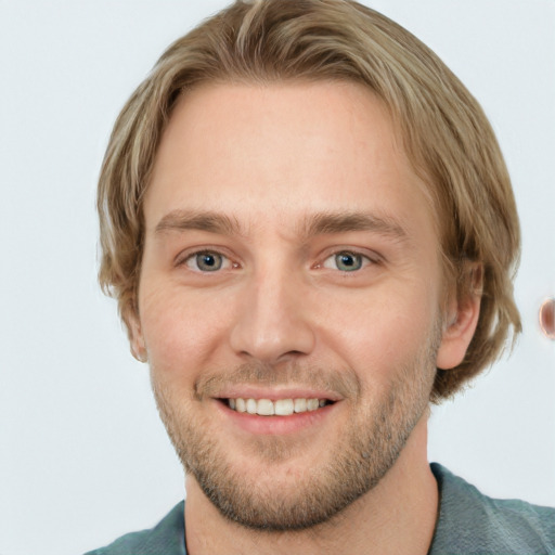 Joyful white adult male with short  brown hair and blue eyes