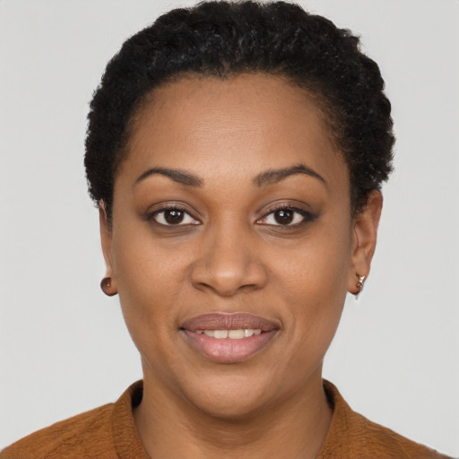 Joyful black young-adult female with short  brown hair and brown eyes