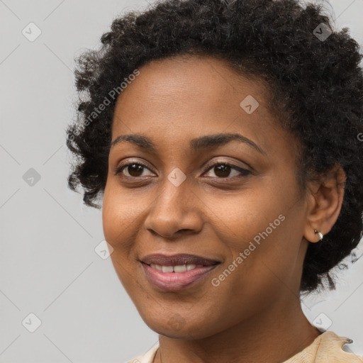 Joyful black young-adult female with short  brown hair and brown eyes