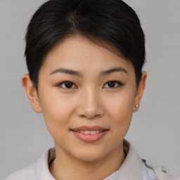 Joyful asian young-adult female with short  brown hair and brown eyes