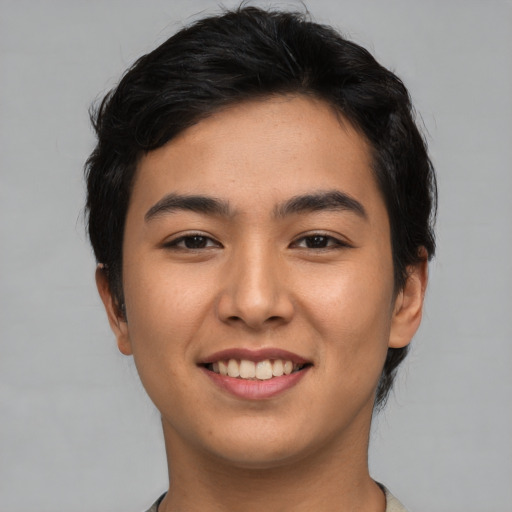Joyful asian young-adult male with short  black hair and brown eyes