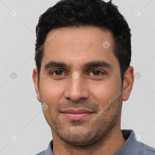 Joyful white young-adult male with short  black hair and brown eyes