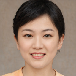 Joyful asian young-adult female with short  brown hair and brown eyes