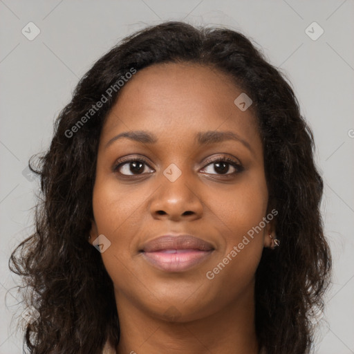 Joyful black young-adult female with long  brown hair and brown eyes