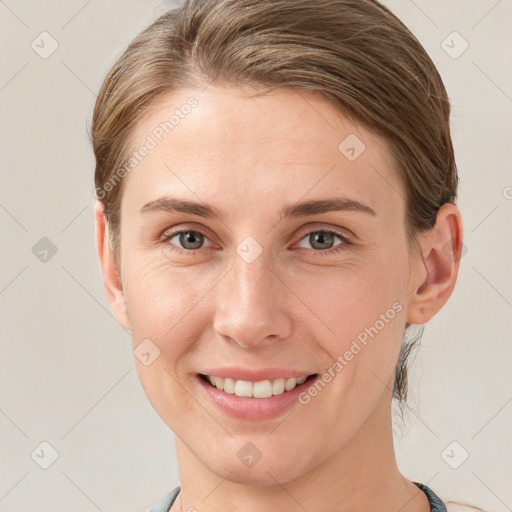 Joyful white young-adult female with medium  brown hair and grey eyes