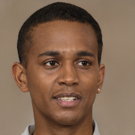 Joyful black young-adult male with short  brown hair and brown eyes