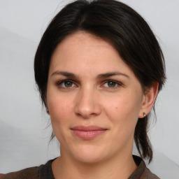 Joyful white adult female with medium  brown hair and brown eyes