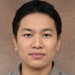 Joyful asian young-adult male with short  black hair and brown eyes