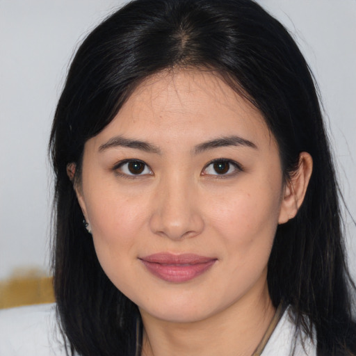 Joyful asian young-adult female with long  brown hair and brown eyes