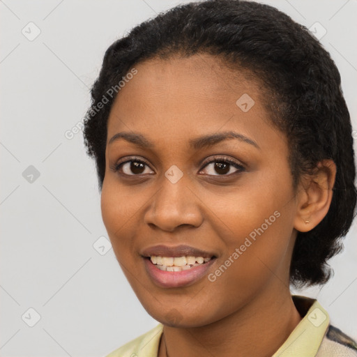 Joyful black young-adult female with short  black hair and brown eyes