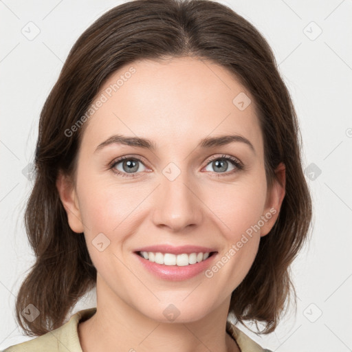 Joyful white young-adult female with medium  brown hair and green eyes