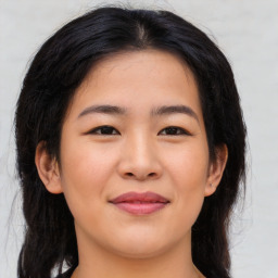 Joyful asian young-adult female with long  brown hair and brown eyes