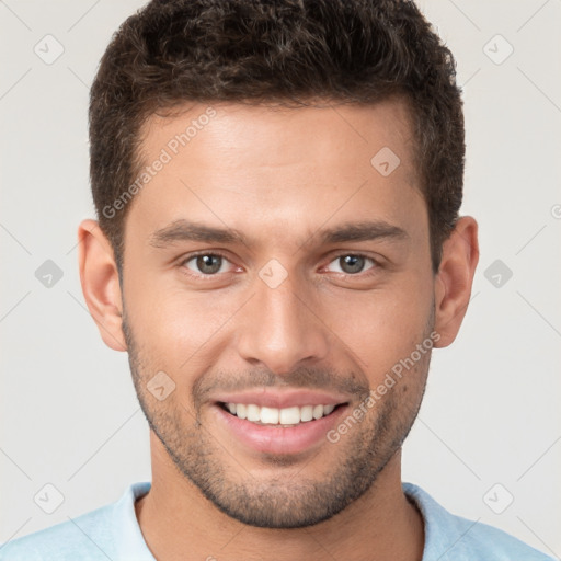 Joyful white young-adult male with short  brown hair and brown eyes