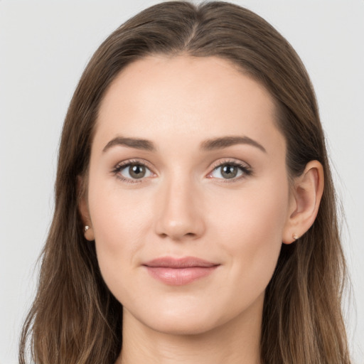 Joyful white young-adult female with long  brown hair and grey eyes