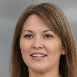 Joyful white adult female with long  brown hair and brown eyes