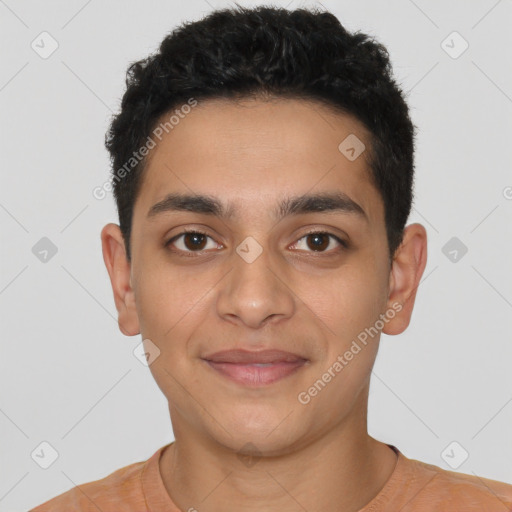 Joyful latino young-adult male with short  black hair and brown eyes