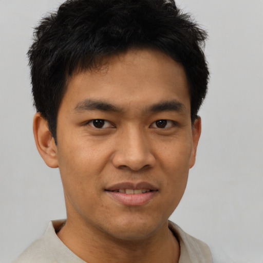 Joyful asian young-adult male with short  brown hair and brown eyes
