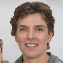 Joyful white adult male with medium  brown hair and brown eyes