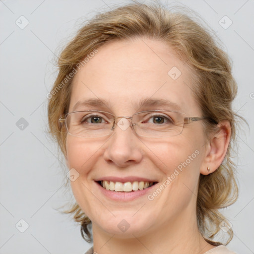 Joyful white adult female with medium  brown hair and blue eyes