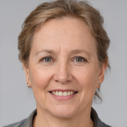 Joyful white adult female with medium  brown hair and grey eyes