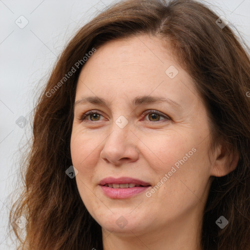 Joyful white adult female with long  brown hair and brown eyes