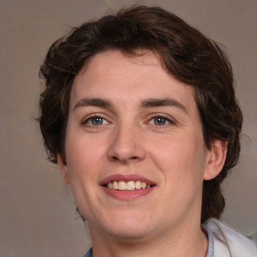 Joyful white young-adult male with medium  brown hair and brown eyes