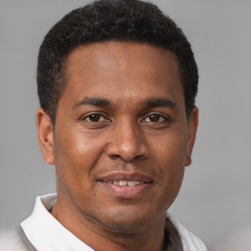 Joyful latino young-adult male with short  brown hair and brown eyes