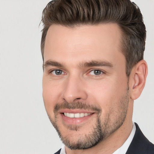 Joyful white young-adult male with short  brown hair and brown eyes