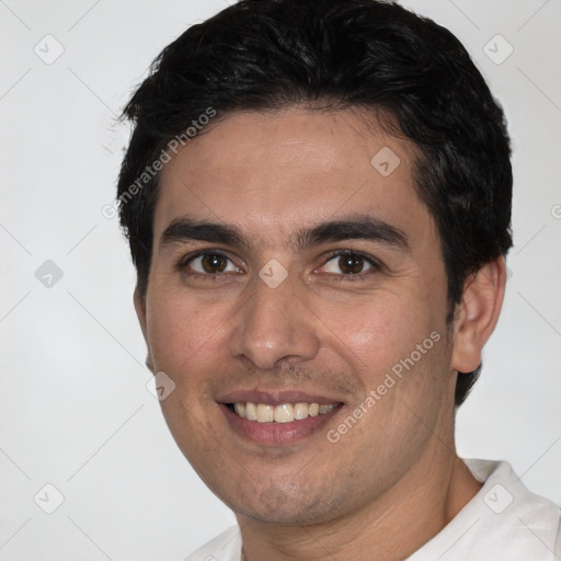 Joyful white young-adult male with short  black hair and brown eyes