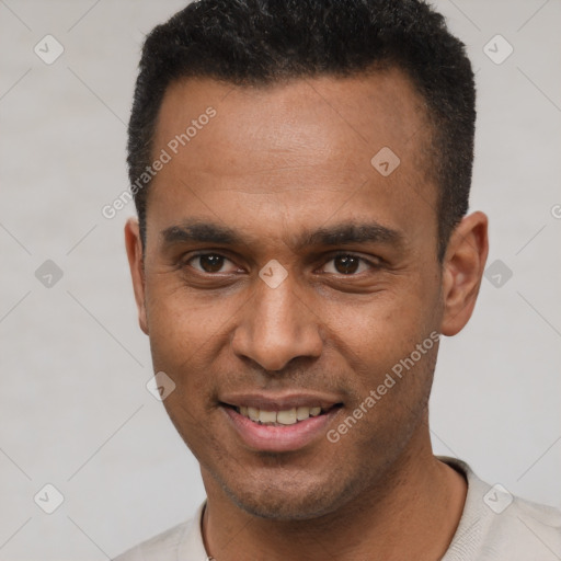 Joyful latino young-adult male with short  black hair and brown eyes
