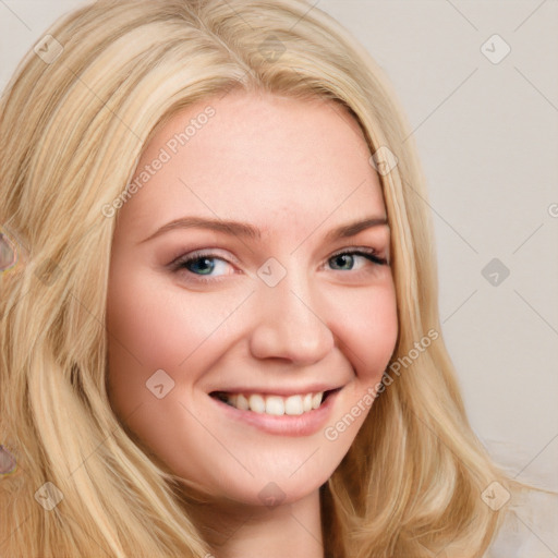 Joyful white young-adult female with long  blond hair and blue eyes